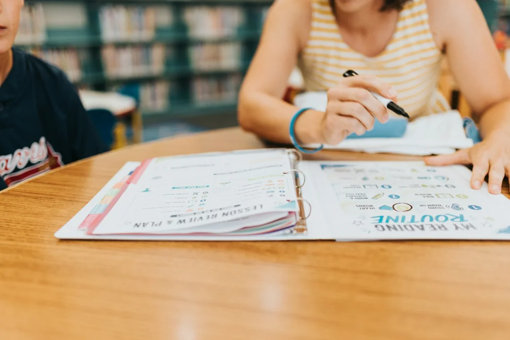 A child completing a language activity at a table